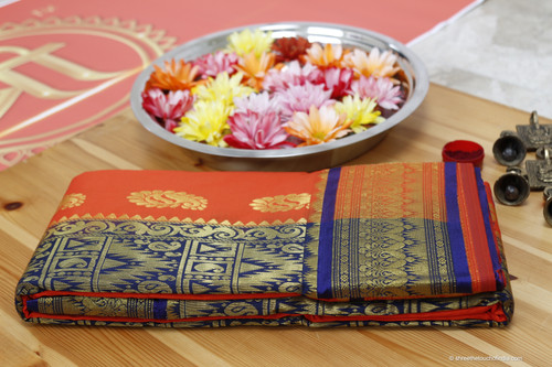 Orange and blue grand Kanchipuram silk saree with full intricate golden zari on a blue base