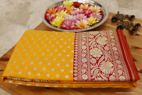 Luxurious mustard and red grand Banarasi Katan silk saree with lush golden and silver zari