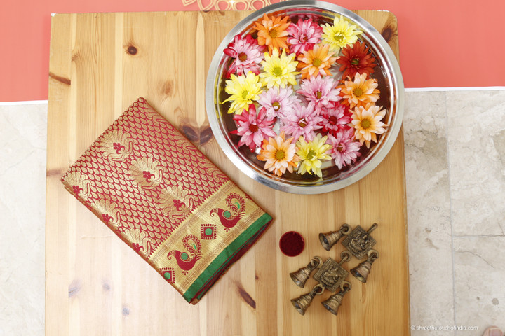 Grand red and golden zari silk saree with a green pallu embellished with zari