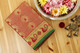 Grand red and golden zari silk saree with a green pallu embellished with zari