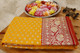 Luxurious mustard and red grand Banarasi Katan silk saree with lush golden and silver zari