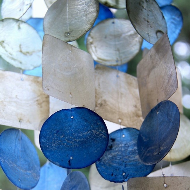 Wind chimes made of thin blue and white shells
