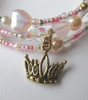 The crown charm symbolizes Cinderella's destiny.