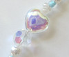 Delicate glass heart beads further indicate the themes of love and compassion.