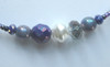 Deep blue and purplescent beads evoke sunlight on the ocean after a storm.