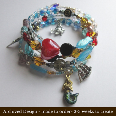 Beads and charms symbolize characters and events in the tale of the Little Mermaid.