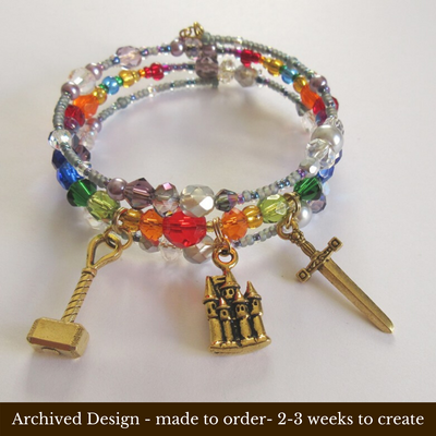 Storm colored beads frame rainbow colored faceted beads and crystals to symbolize the Rainbow Bridge to Valhalla.
