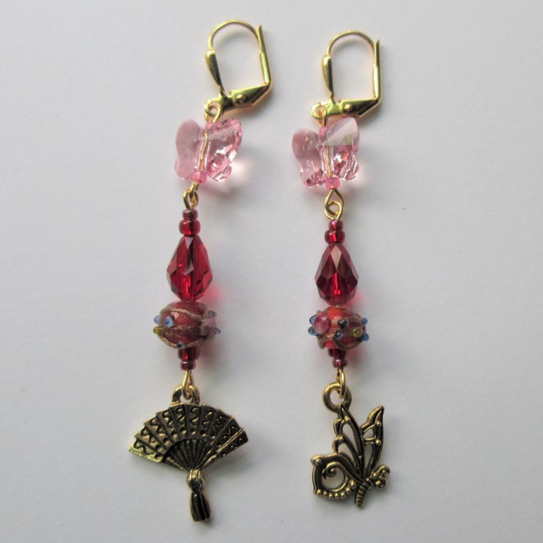 The Madama Butterfly earrings symbolize Puccini's tragic tale through symbolic beads and charms- a perfect gift for opera fans.