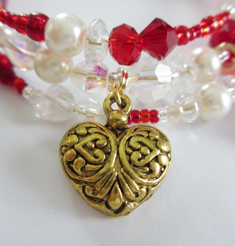 A heart charm represents Musetta's love and compassion beneath her flirtatiousness and bluster.