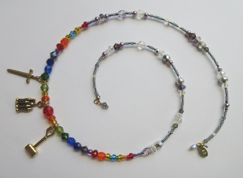 Storm colored beads frame rainbow colored faceted beads and crystals to symbolize the Rainbow Bridge to Valhalla.