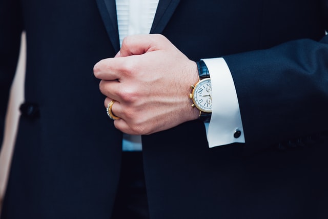 Man wearing a dress watch with a suit