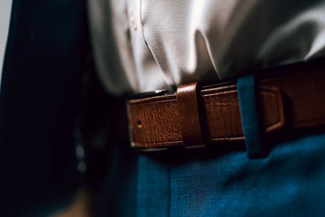 A close-up of a brown formal belt