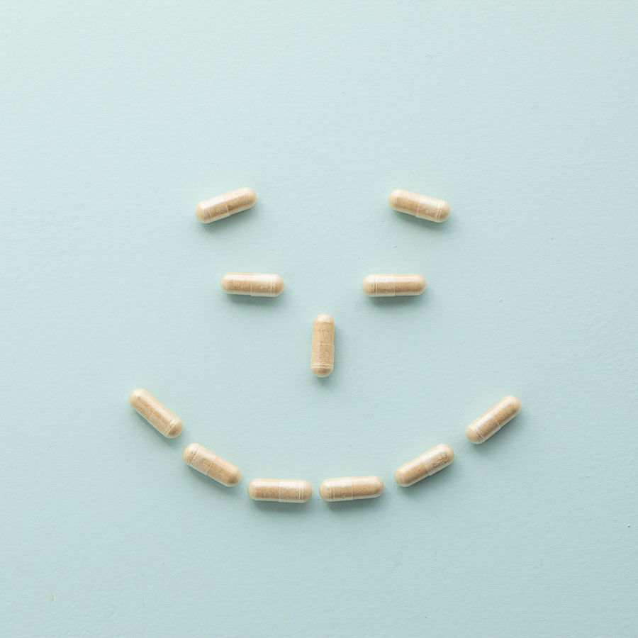Maca capsules arranged in a smile