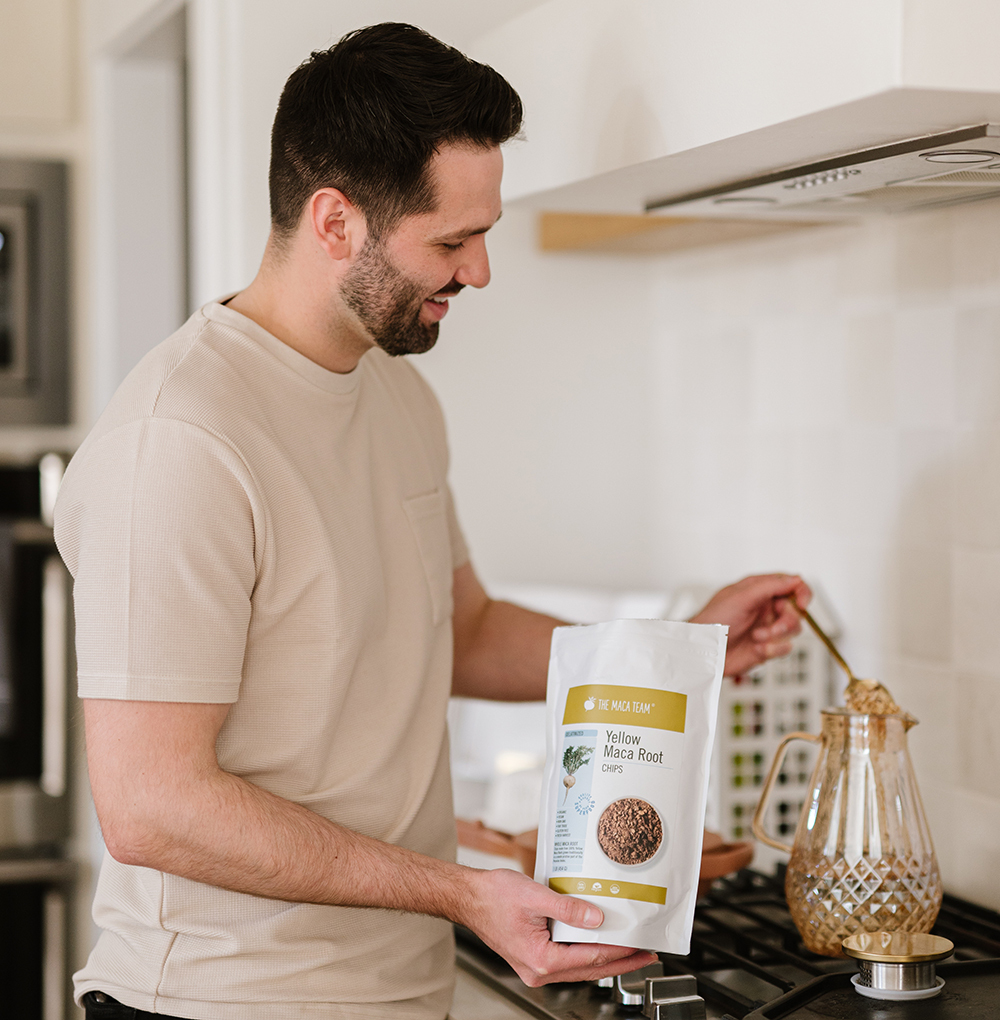Man holding dried yellow maca root chips