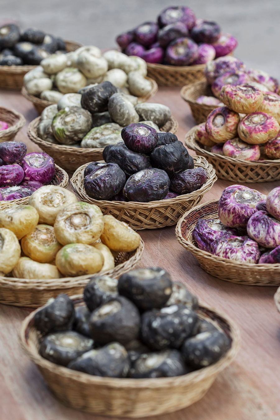 Red, black, and yellow fresh maca roots shown side by side