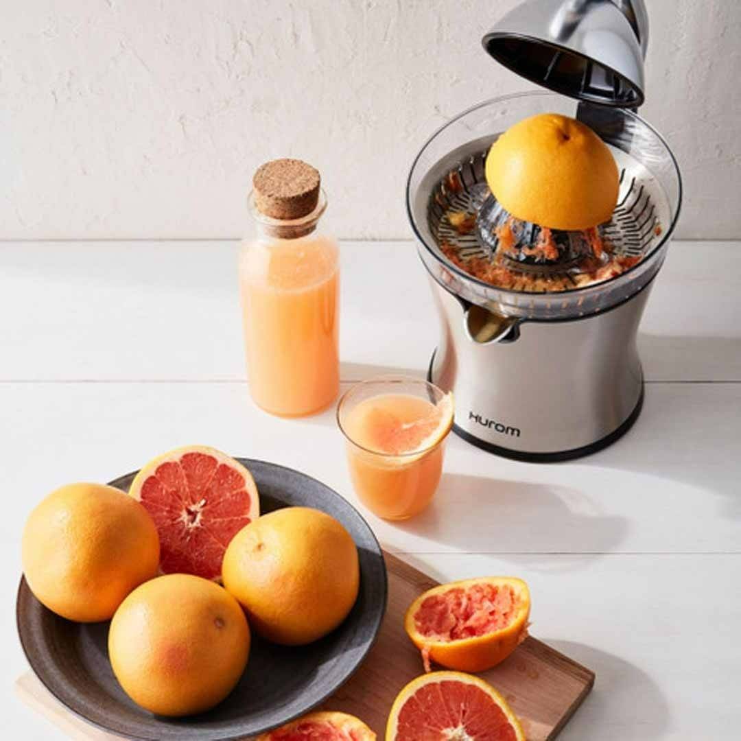 Hurom CJ Citrus juicer in stainless steel juicing oranges