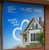 Custom real estate perforated window decal featuring a modern white house with blue background, heart graphic, and text promoting Blue Family Realty services, workshops, and free market analysis.