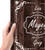 The sign is held by a hand, showing a design with a wood-like background and ornate white text and decorative flourishes.
The names “Lisa” and “Greg” appear along with a large decorative “Mayer,” with an established year “est. 202_” (likely a placeholder for customization).
The text is framed with arrows, hearts, and scroll-like designs.
The sign is mounted on the wall using small, round metal fasteners.