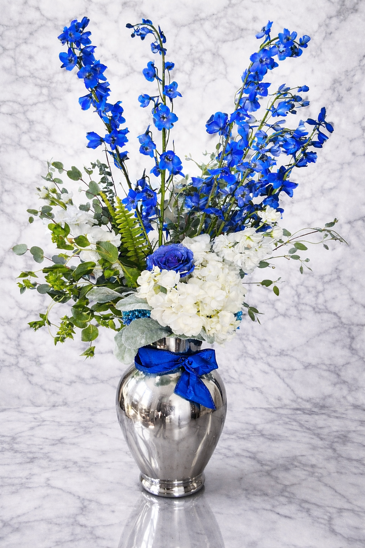 Mirrored sophisticated arrangement with blue elegant blue delphiniums