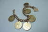 14K Yellow Gold 7 inch Bracelet w/Euro Coins and Gold Charms.