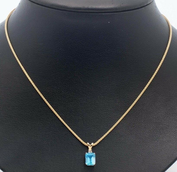 14K Yellow Gold Blue Topaz and Diamond Chip Pendant on a 16" Chain