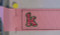 Picture of the stitched #520_SM_1RibbonTemp design with a "k" from our #359 Zebra Filled Font as an example [no font is included in this set].
