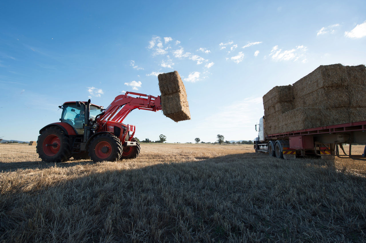 Kubota tractor lifting bale