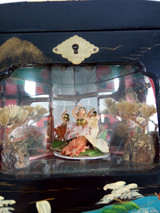 intricately designed box features a mechanical shadow box, dancing geisha girl