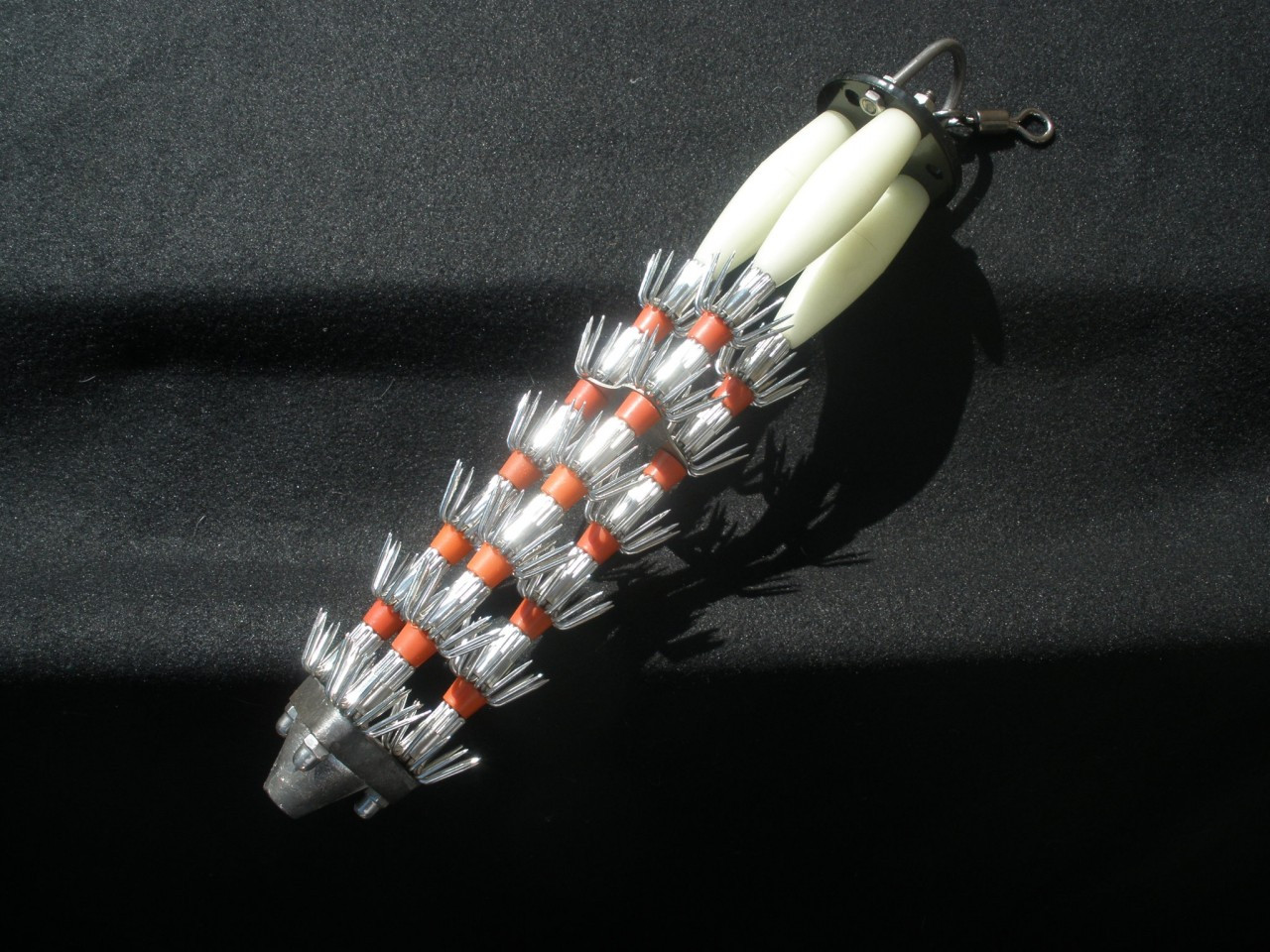 GIANT SQUID JIG, Three rows of teeth and three glow in the dark tubes - heavy weighted bottom - you'll be filling the bait tank with live squid in no time.450 grams a bit over one pound. 32CM x 6CM x 6CM