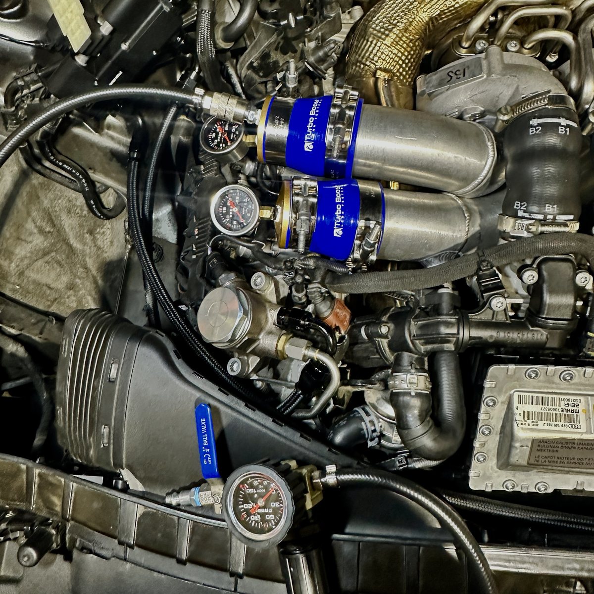 Two testers with gauges on a twin-turbo V8