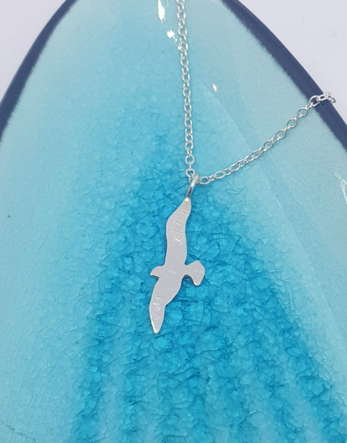 Elegant winded silver bird necklace who dreams of flying off and making their own adventures.