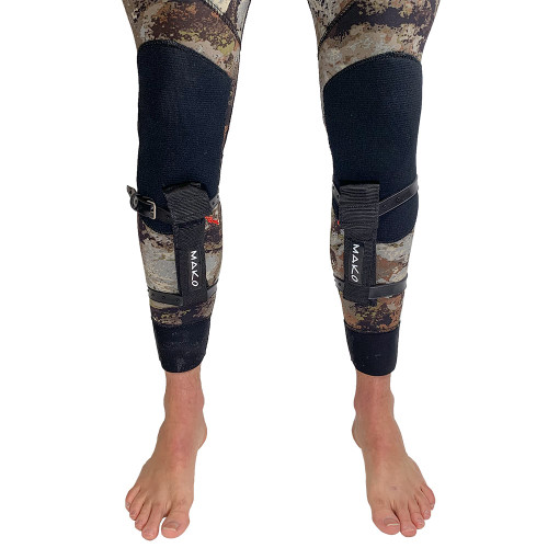 Camo and black neoprene shin weights with adjustable straps worn on both legs, front view