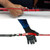 Pole spear resting hook demonstrated on red spear with hand grip, shown from side angle with mounted attachment detail