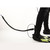Ocean Guardian Shark Shield for SCUBA attached to diver's leg in black wetsuit and yellow fins, side view