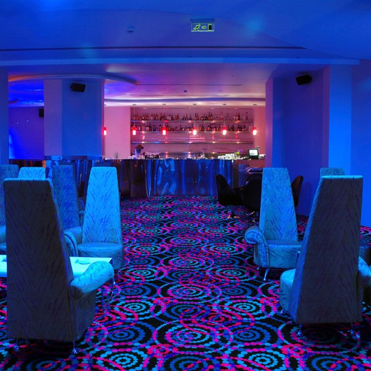 Joy Carpets Neon Lights Dottie Fluorescent 447 Commercial Broadloom Carpet Room Scene