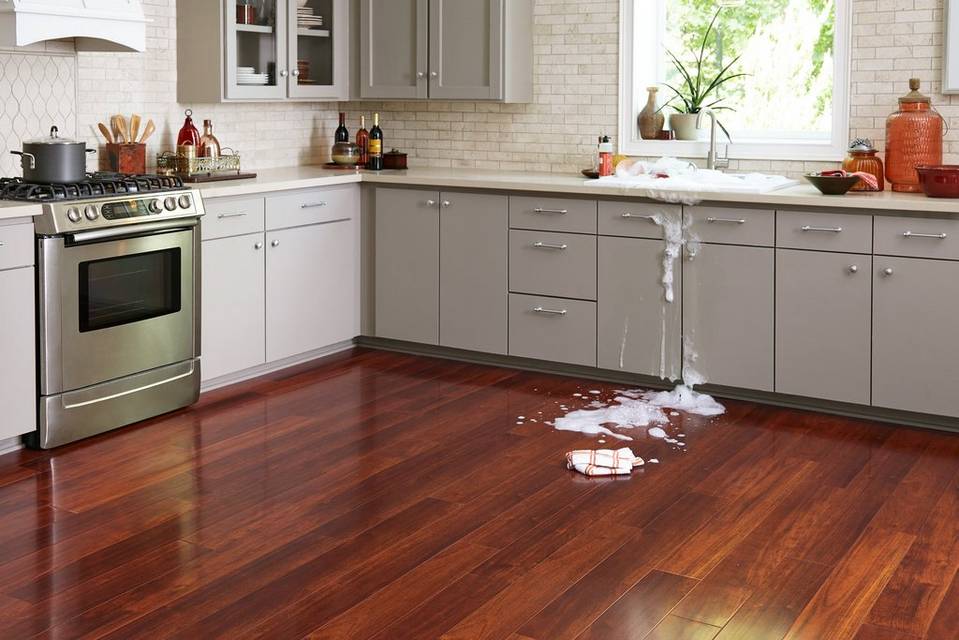 Sink water spilling over on to floor in kitchen 