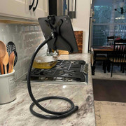 Flexible iPad stand shown tall in kitchen next to stove