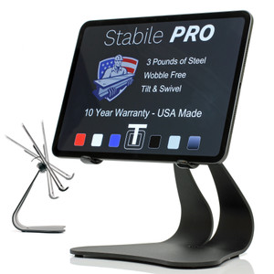 Stabile PRO Black steel iPad stand holding an iPad in landscape orientation, screen displaying features: 3 pounds of steel, wobble free, tilt and swivel, USA made 10 year warranty. Small inset shows tilt motion range on left.