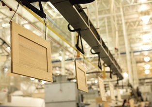 Overhead conveyor system moving cabinet doors through the manufacturing process at the Masterpiece Middlefield, Ohio, plant