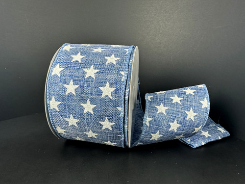A 2.5 inch wide roll of blue poly linen wired ribbon with a denim-look texture, featuring a bold, scattered pattern of solid white stars.
