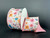 A 2.5 inch wide roll of light-colored poly linen wired ribbon featuring a dense pattern of vibrant pink, orange, and yellow wildflowers with a pink stitched edge.