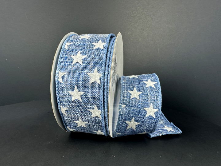 A 1.5 inch wide roll of blue poly linen wired ribbon with a denim-look texture, featuring a scattered pattern of solid white stars.