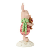 Disney Piglet Holiday Mini Jim Shore Disney Traditions Figurine 6018717, a carved and painted figurine of Piglet from Winnie the Pooh dressed in holiday attire holding a teddy bear.