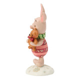 Disney Piglet Holiday Mini Jim Shore Disney Traditions Figurine 6018717, festive figurine featuring Piglet from Winnie the Pooh holding a bunny, decorated in holiday attire with colorful details and standing on a snowflake-design base.