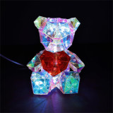 Disney Prism Bear with Heart 5 inch Crystalline Style Light-Up Figurine, illuminated and made of multicolored transparent crystal-like geometric shapes, featuring a red heart on its chest.