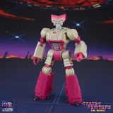 Transformers Kranix Transformers Studio Series The Movie Deluxe Class 5.5-Inch Action Figure, a detailed robot toy with a beige and pink color scheme, standing against a space-themed background with stars and a silhouette of planets.