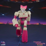 Transformers Kranix Transformers Studio Series The Movie Deluxe Class 5.5-Inch Action Figure, a detailed toy with beige and pink color scheme, standing against a space-themed background.
