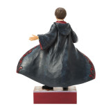 Enesco Harry Potter Magical Moment Jim Shore 10 Inch Figurine, detailed sculpture of Harry Potter in a spellcasting pose with a flowing black cloak and red accents, part of the Harry Potter Collection.