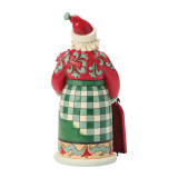 Enesco Santa with Sled Highland Glen Jim Shore 8 Inch Figurine Heartwood Creek 6019271, a decorative Christmas figurine of Santa Claus with a detailed red, green, and cream color palette, wearing a festive outfit and holding a red sled.