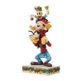 Disney Mickey, Donald & Goofy Stacked Jim Shore 8.5 Inch Figurine Disney Traditions, a colorful Christmas-themed collectible figurine featuring Mickey Mouse, Donald Duck, and Goofy stacked on top of each other, with festive decorations and vibrant colors.
